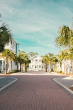 white and blue concrete building near palm trees during daytime