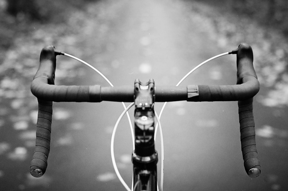 grayscale photo of water droplets on metal fence