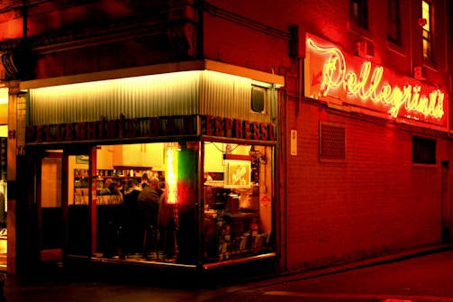 A warm, inviting local café scene with people enjoying food and conversation.