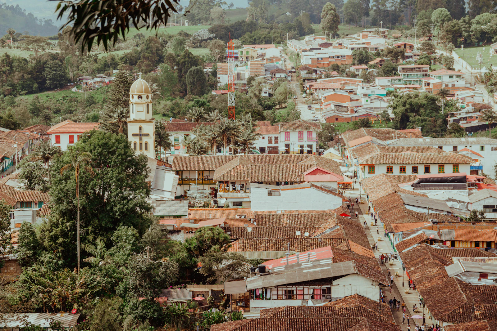 Salento’s tiled roofs and church among green hills