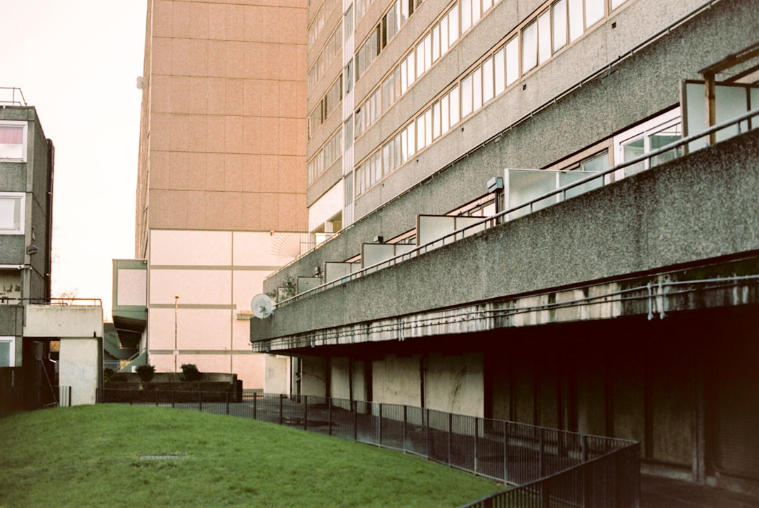 green grass field near brown concrete building