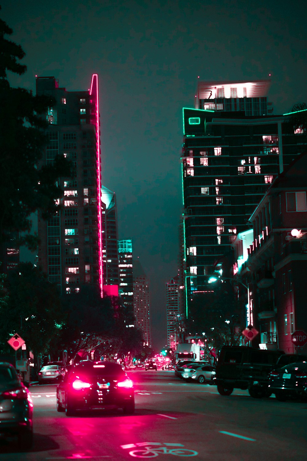 cars on road near high rise building during night time