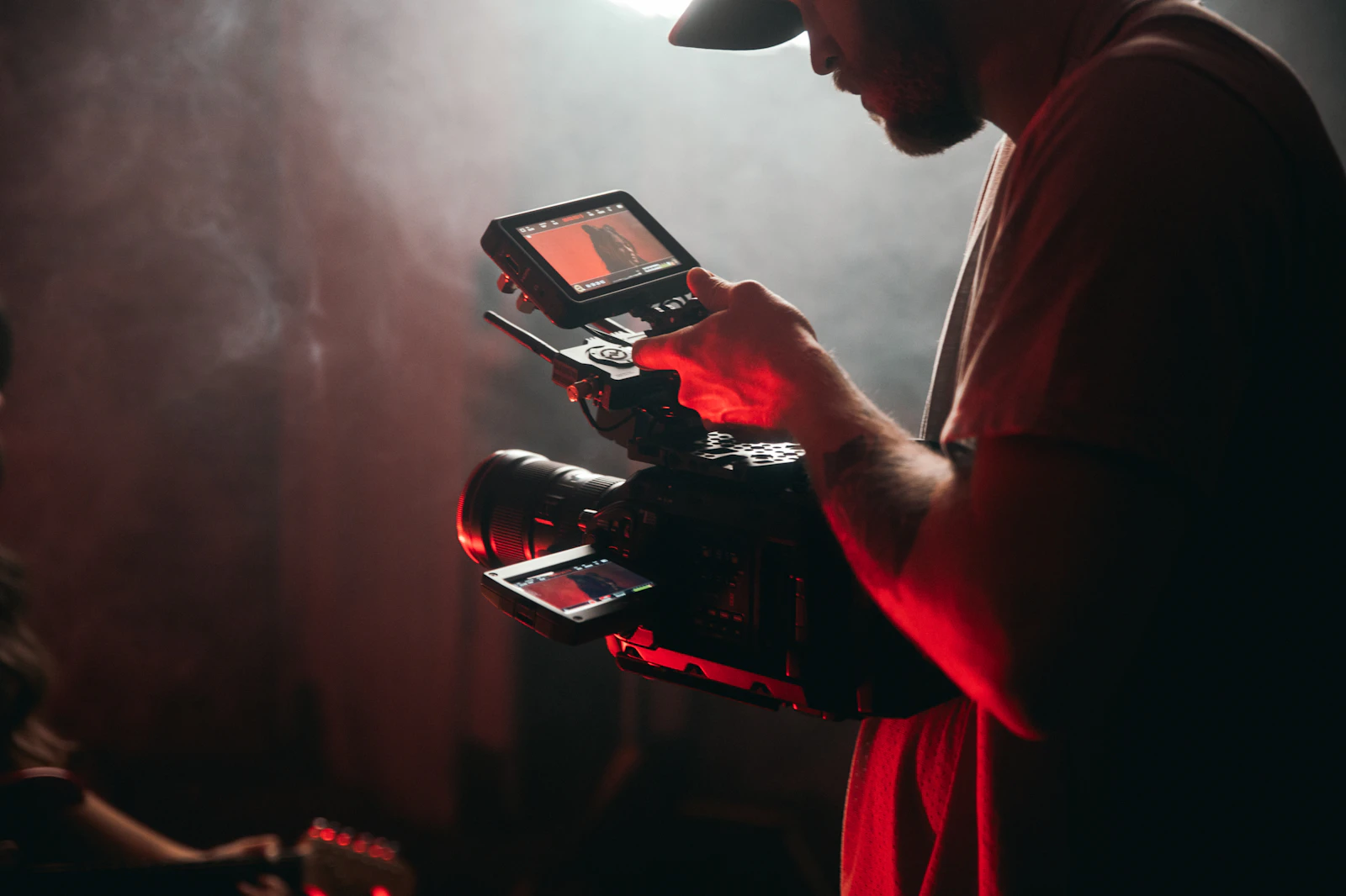 Camera operator holding a video camera on set