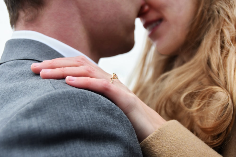 woman in gold ring and white shirt