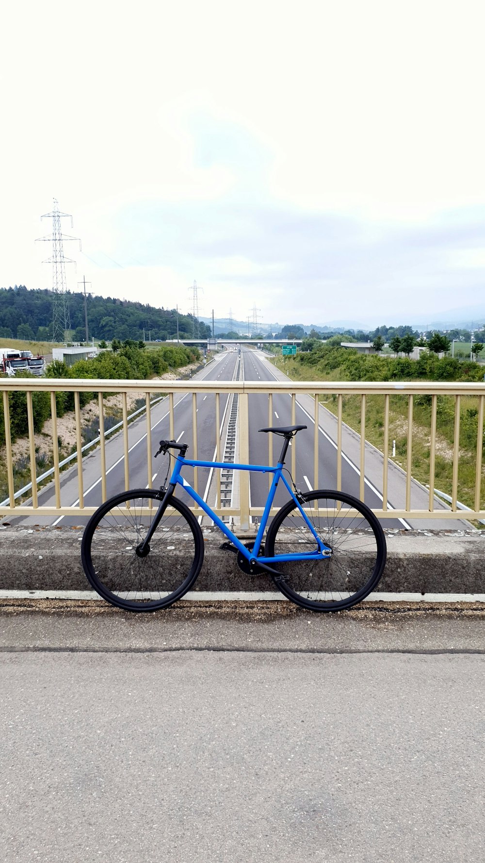 blue and black road bike on gray concrete road