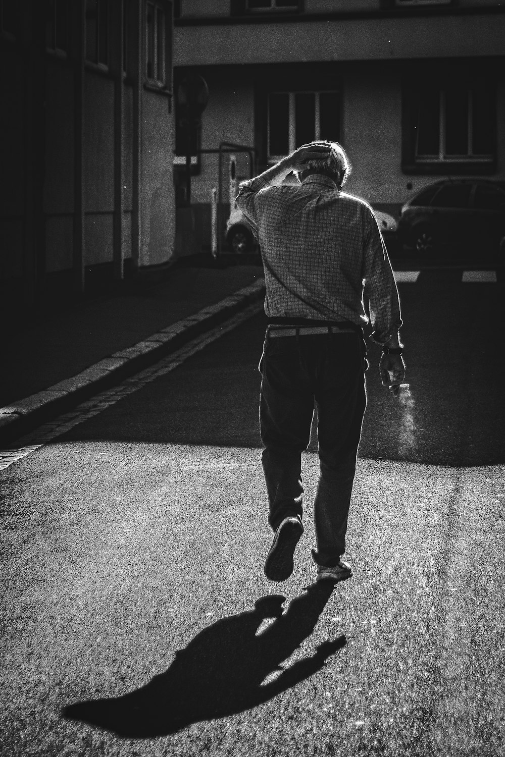 man in gray hoodie walking on street