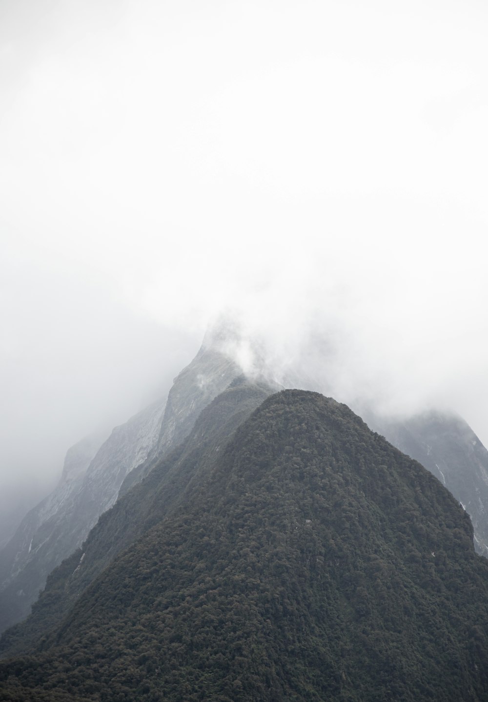 green and black mountain under white clouds