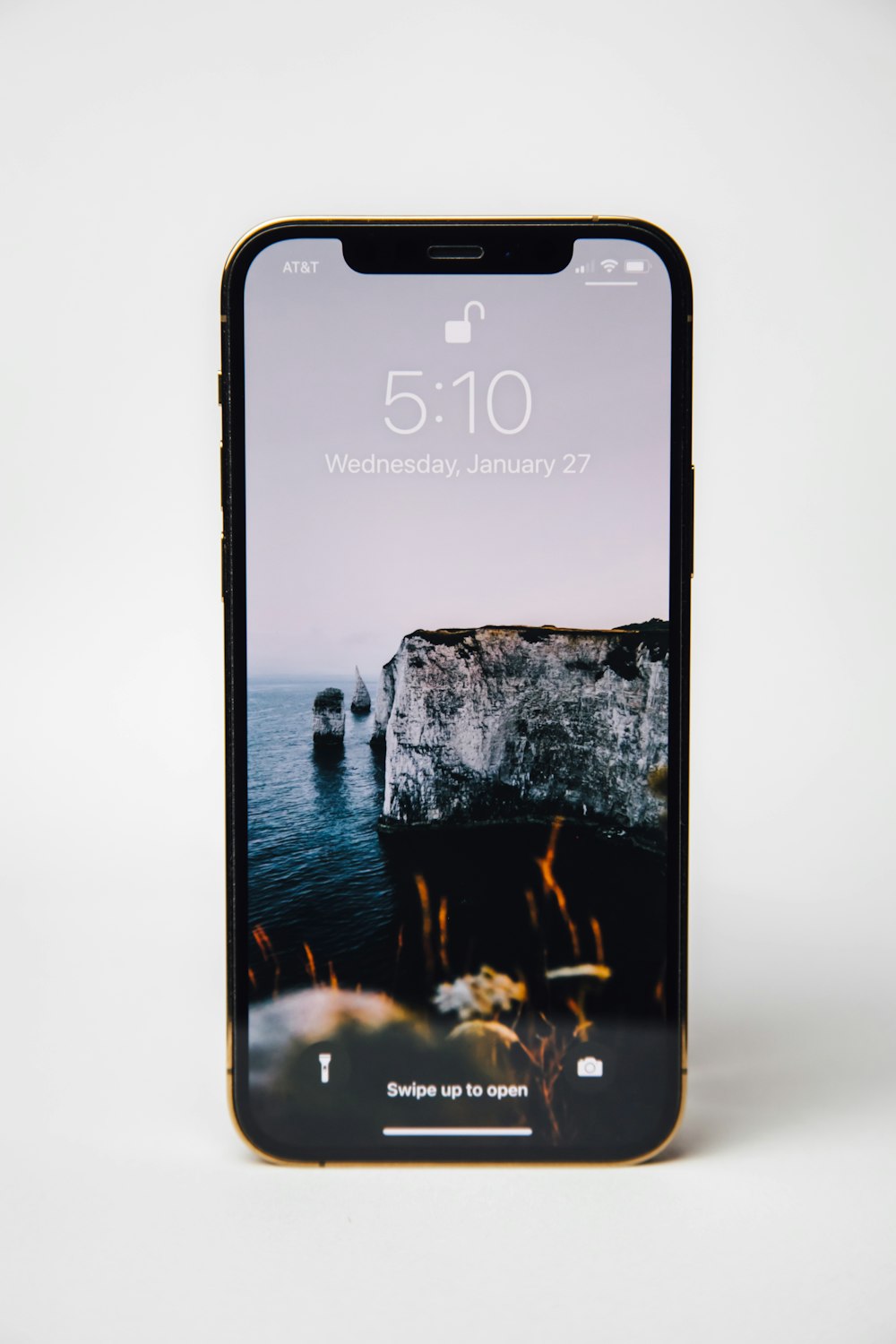 silver iphone 6 displaying rock formation on water
