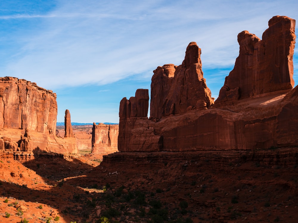 brown rock formation under white clouds during daytime