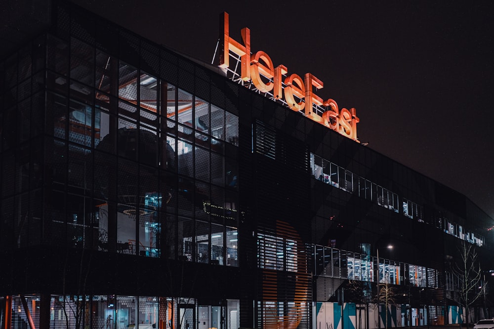 lighted building with red lights during night time