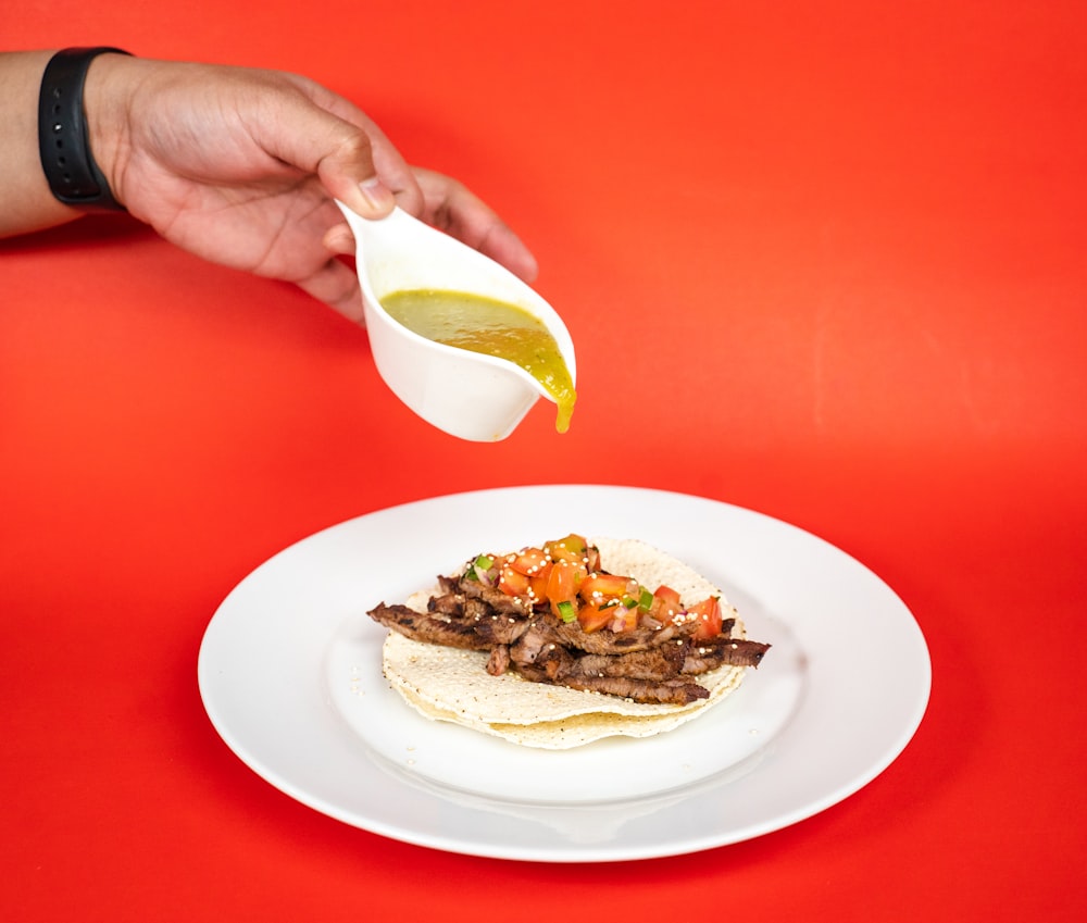 person holding white ceramic plate with sliced lemon