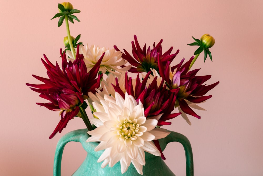 white and pink flowers in green watering can