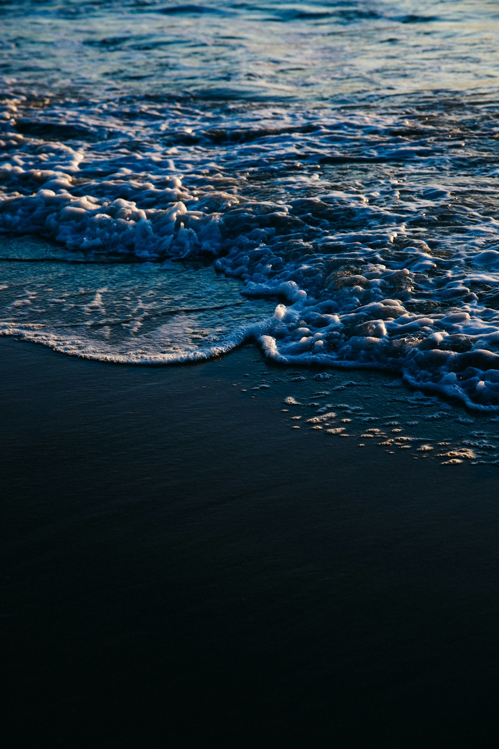 water waves on shore during daytime