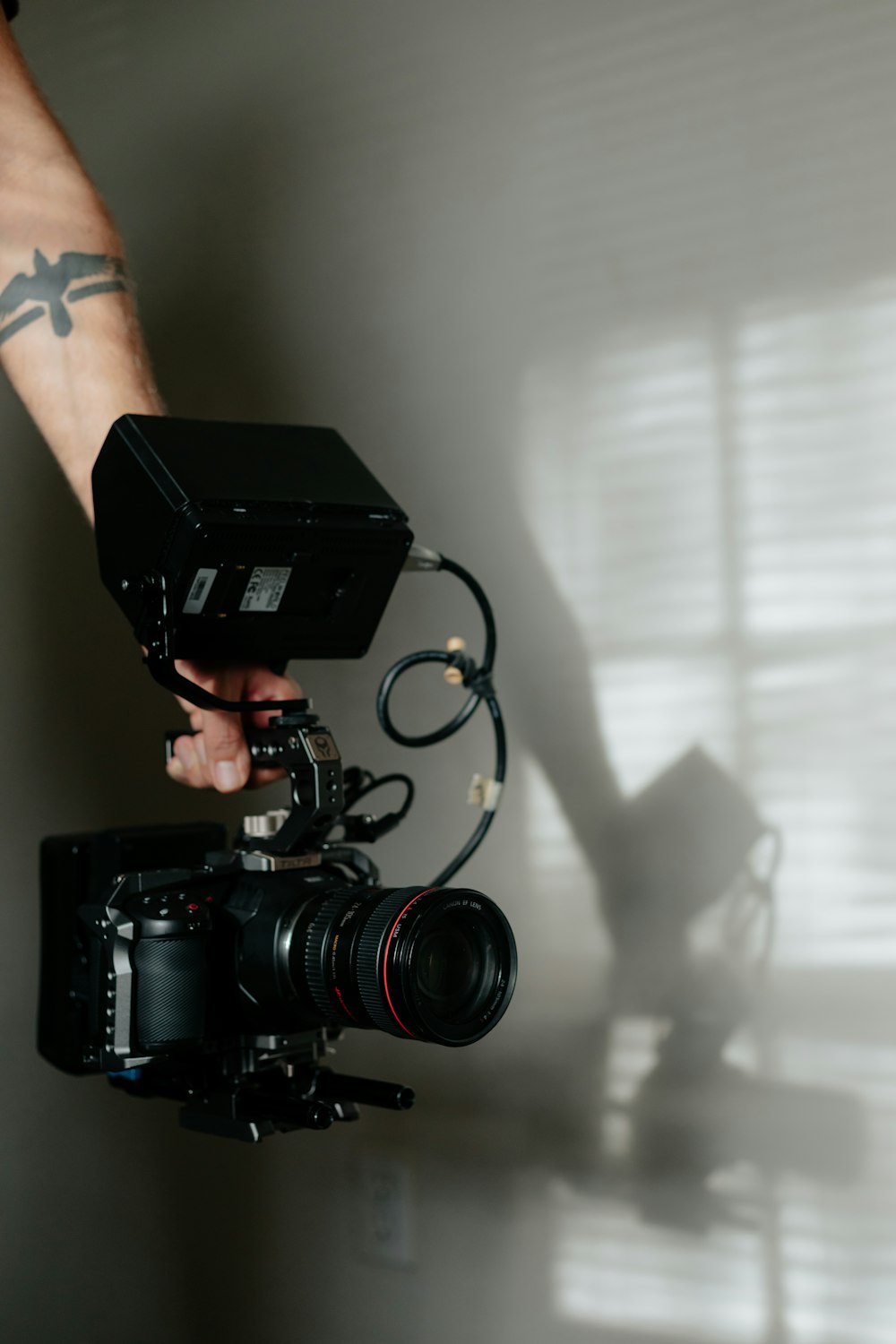 person holding black dslr camera