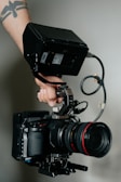 person holding black dslr camera