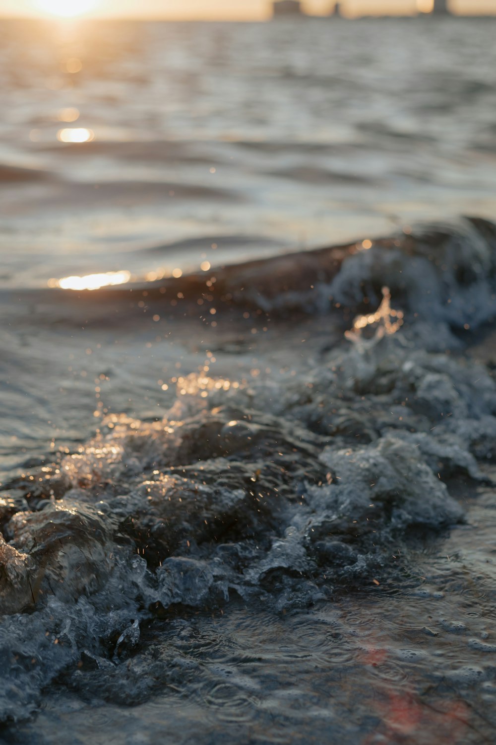 water waves on brown rocky shore during daytime