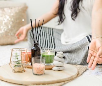 woman in white tank top holding black chopsticks