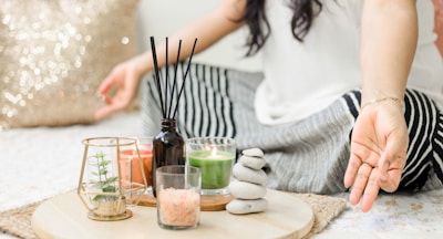 woman in white tank top holding black chopsticks