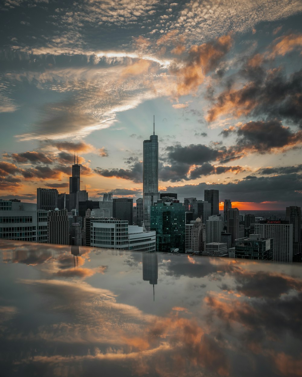 city skyline under cloudy sky during sunset