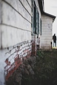 A still from the documentary showing the house's weathered facade at dusk.