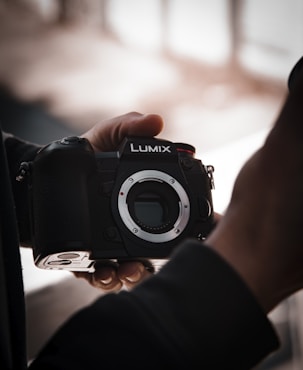 person holding black nikon dslr camera