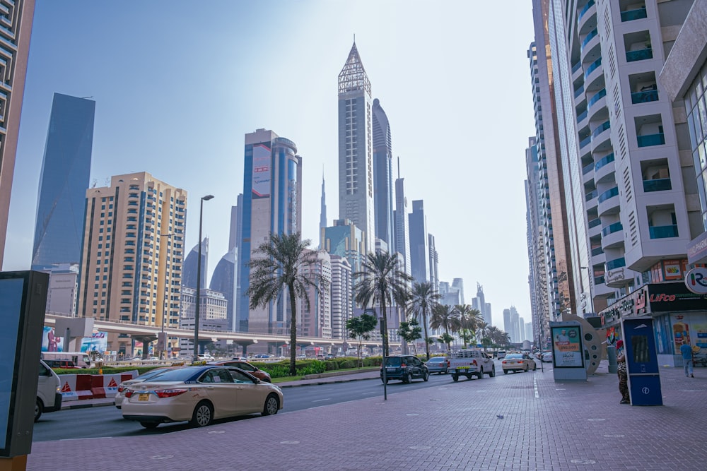 cars on road near high rise buildings during daytime