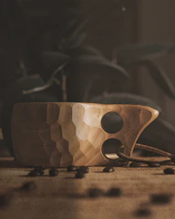 Close-up of a beautifully crafted organic coffee cup on a wooden table.