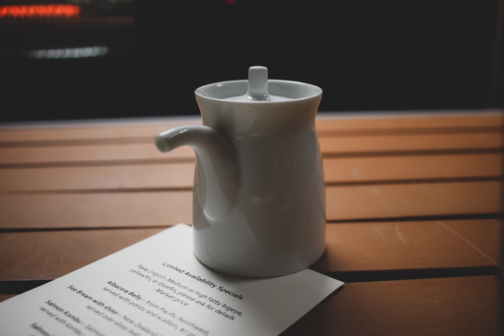 white ceramic teapot on white printer paper