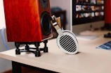 Studio tete a tete's soundboard and headphones neatly arranged on a white desk.