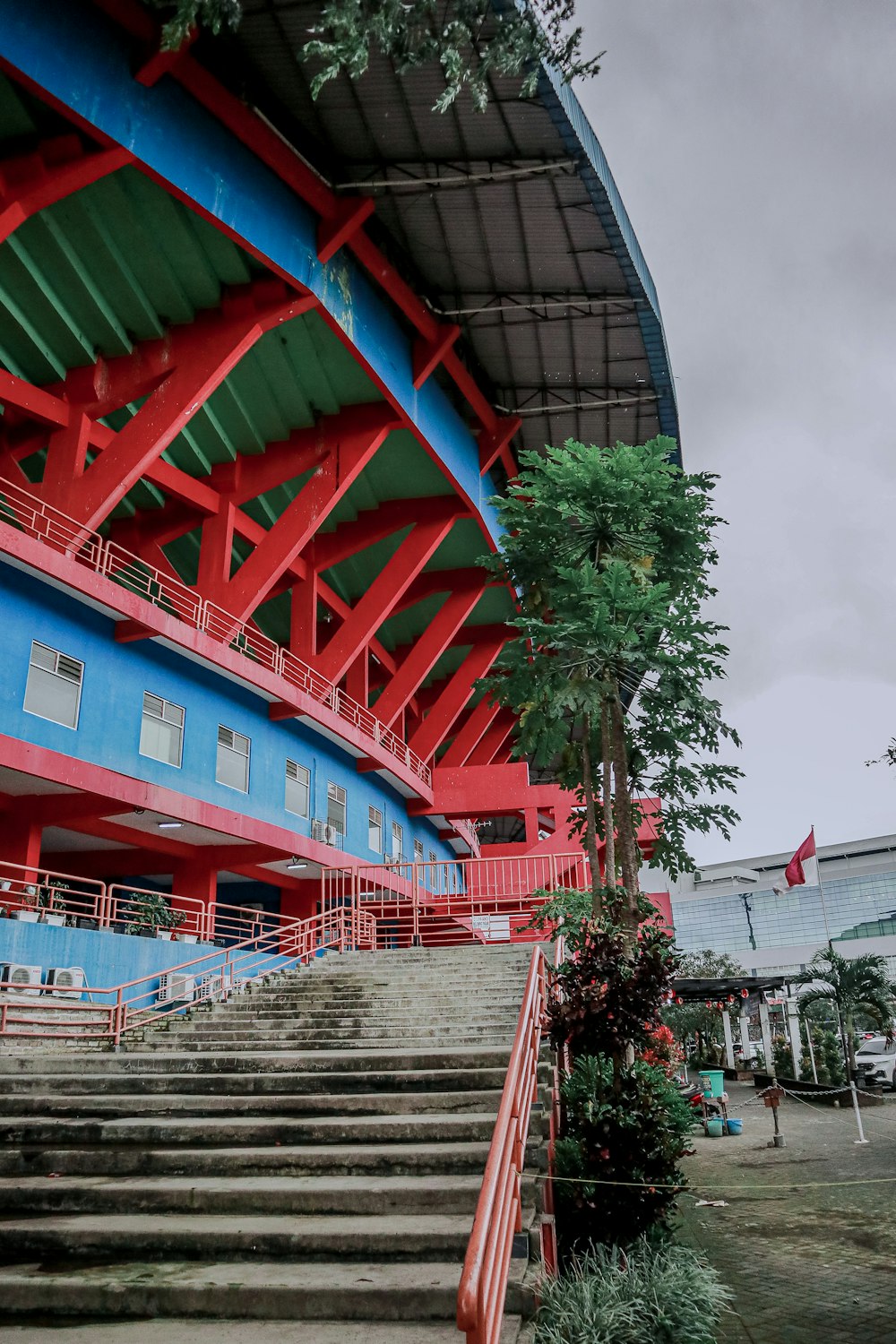 a red and blue building with stairs leading up to it