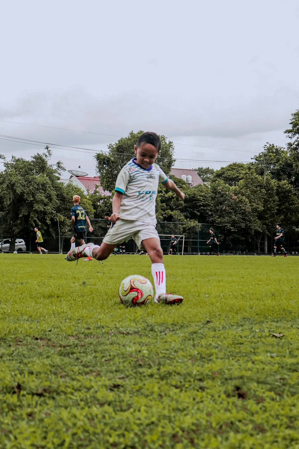 a person kicking a soccer ball on a field