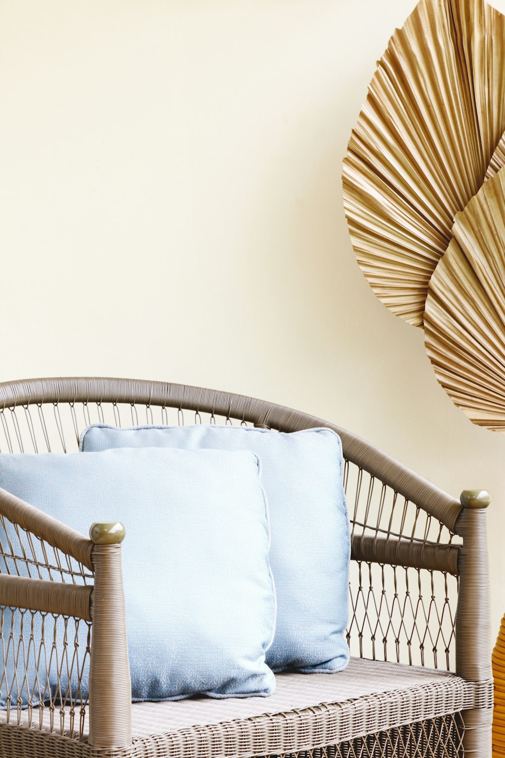 brown wooden framed white padded armchair