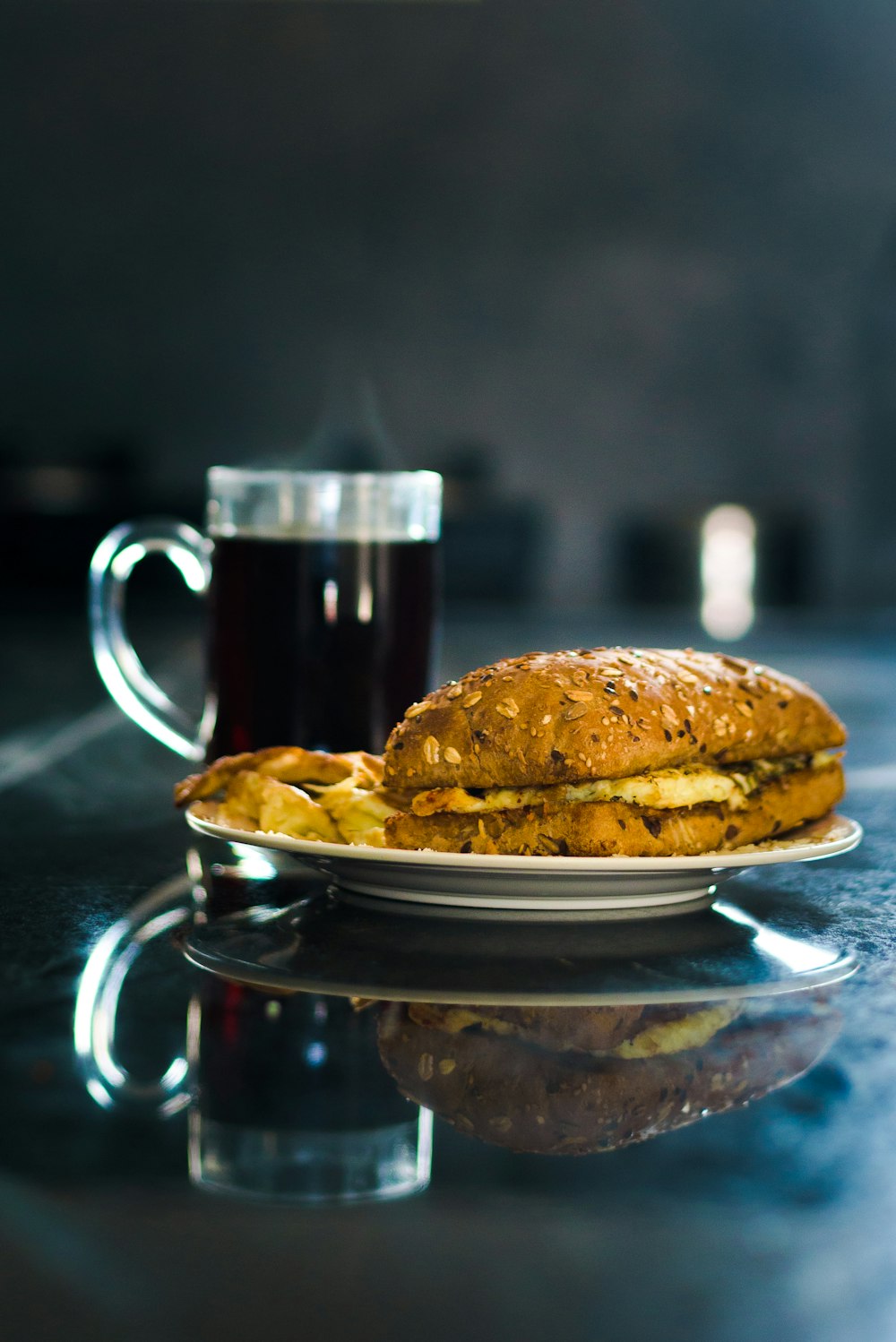 a plate with a sandwich and a cup of coffee