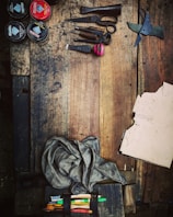 An assortment of sewing supplies displayed on a rustic wooden table.