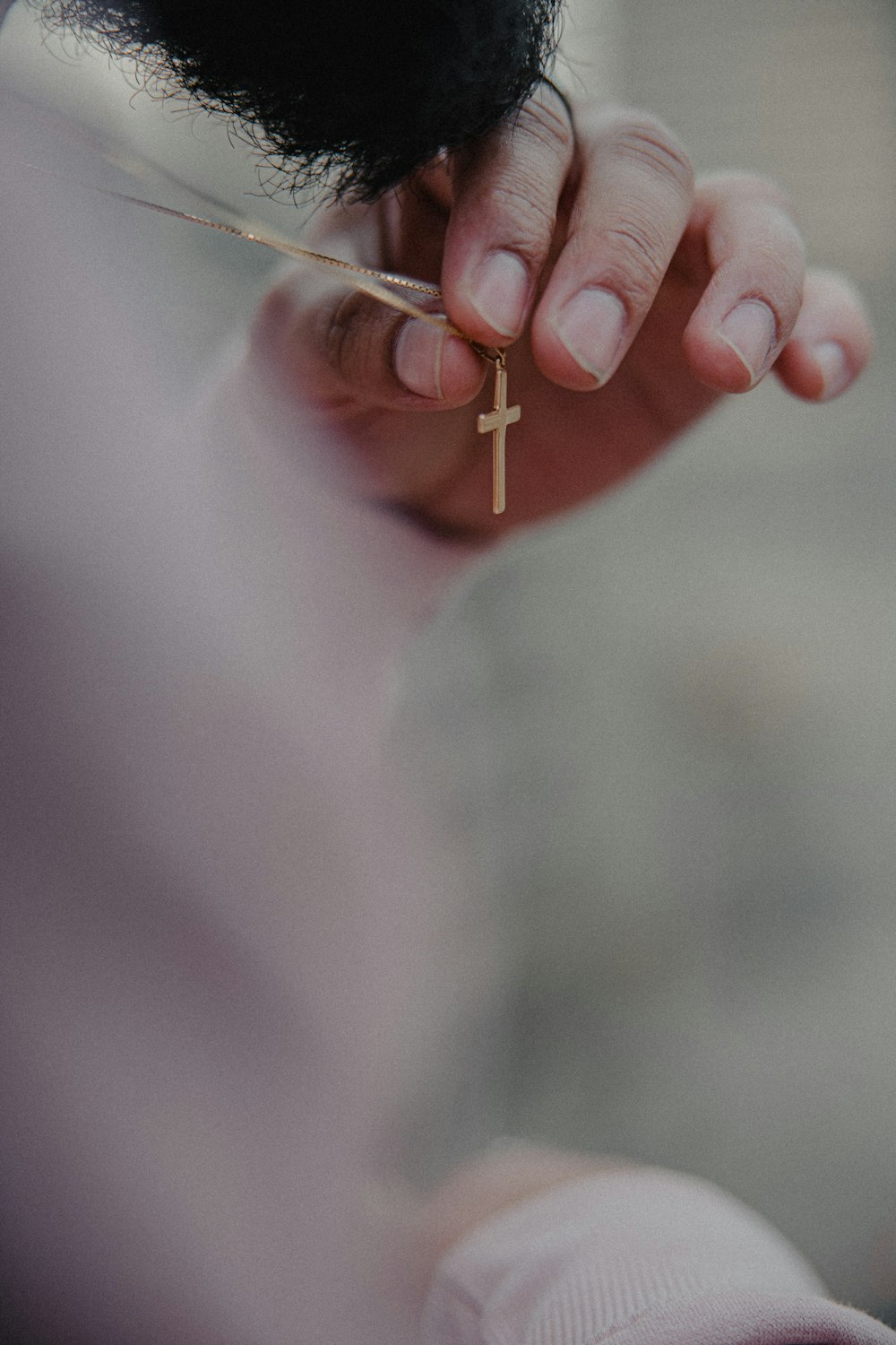 person holding silver pin in close up photography