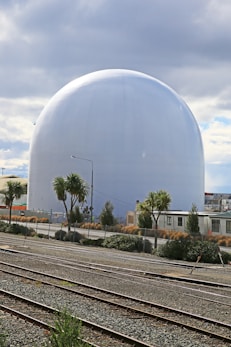 gray round building near green trees during daytime