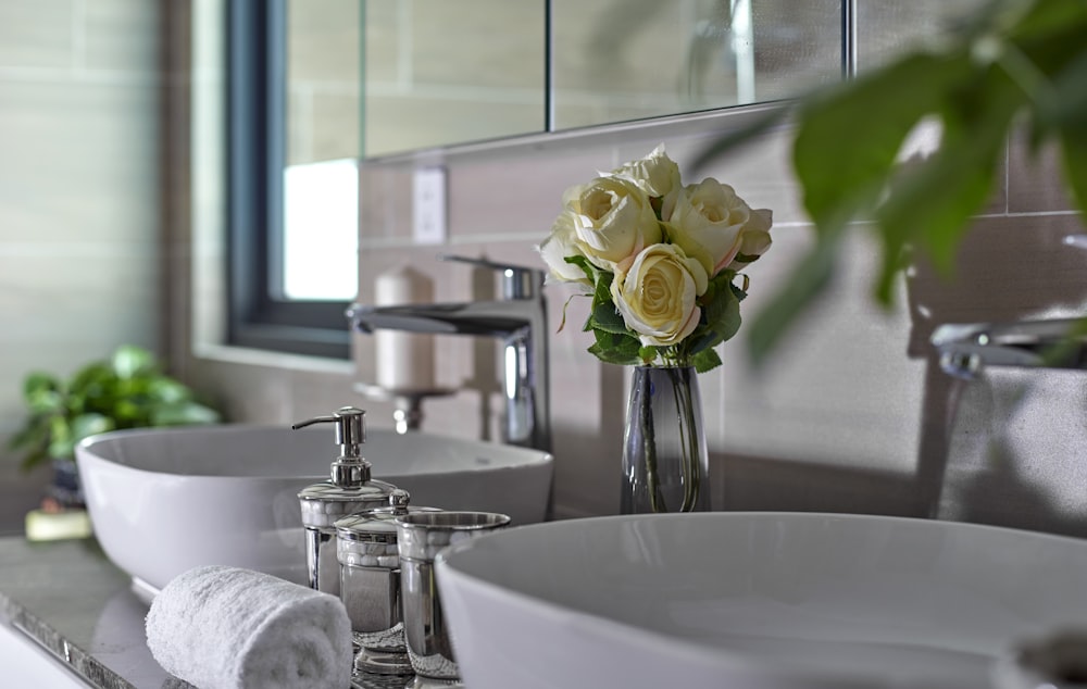 white roses on white ceramic sink