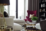 A cozy modern living room with deep maroon curtains held by ghazian’s premium curtain brackets.