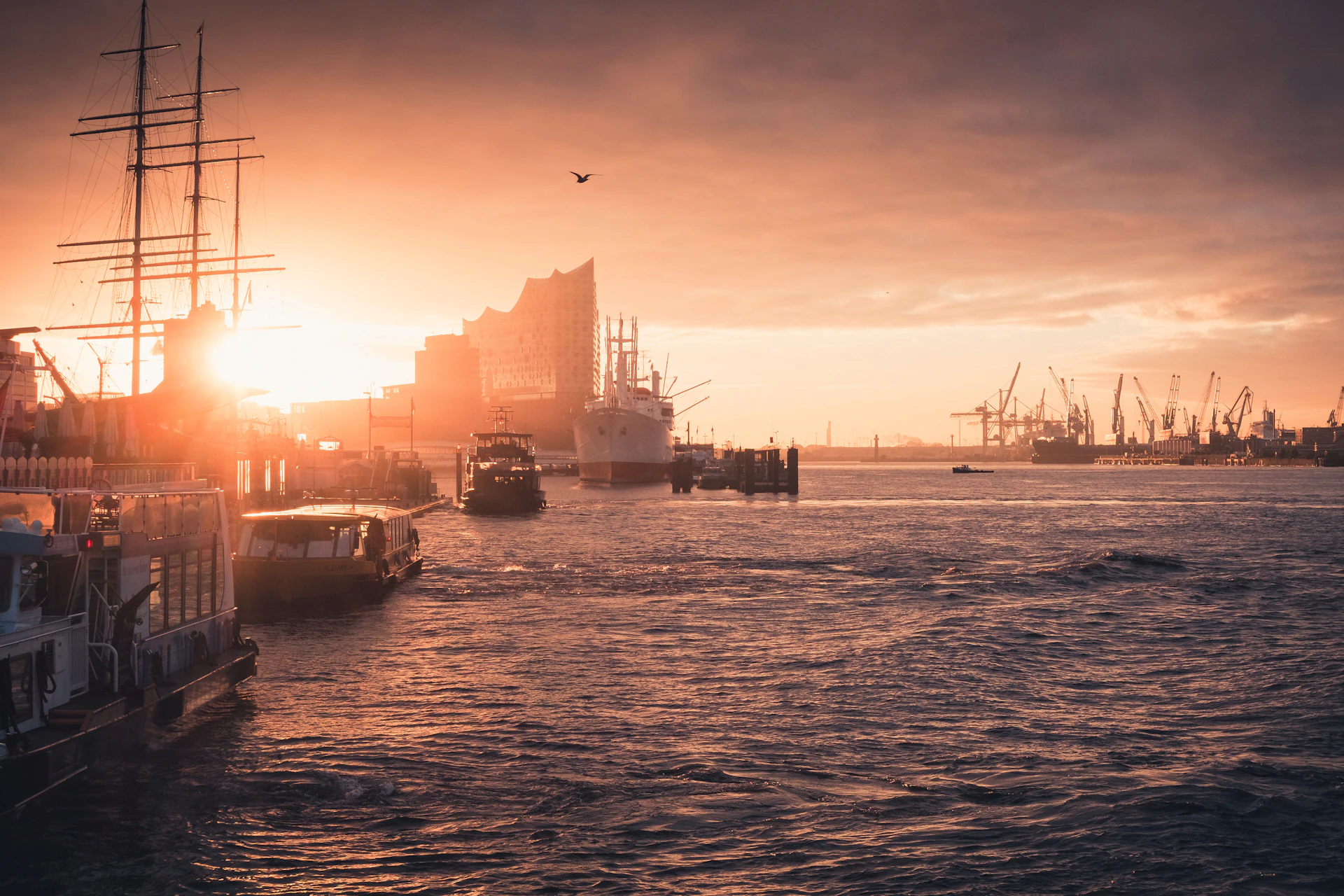 silhouette of boat on sea during sunset