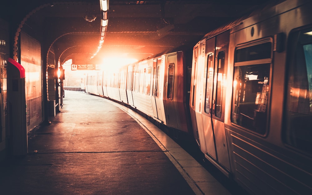 man in black jacket standing beside train