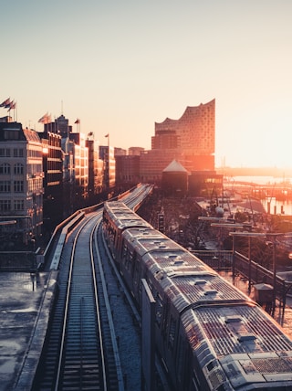 city buildings near the road during sunset