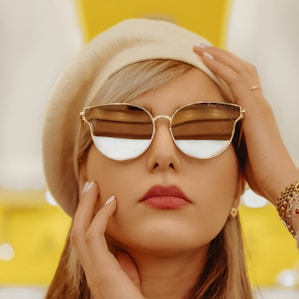 woman wearing gold framed aviator style sunglasses