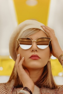 woman wearing gold framed aviator style sunglasses