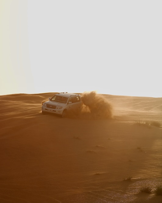 black car on desert during daytime