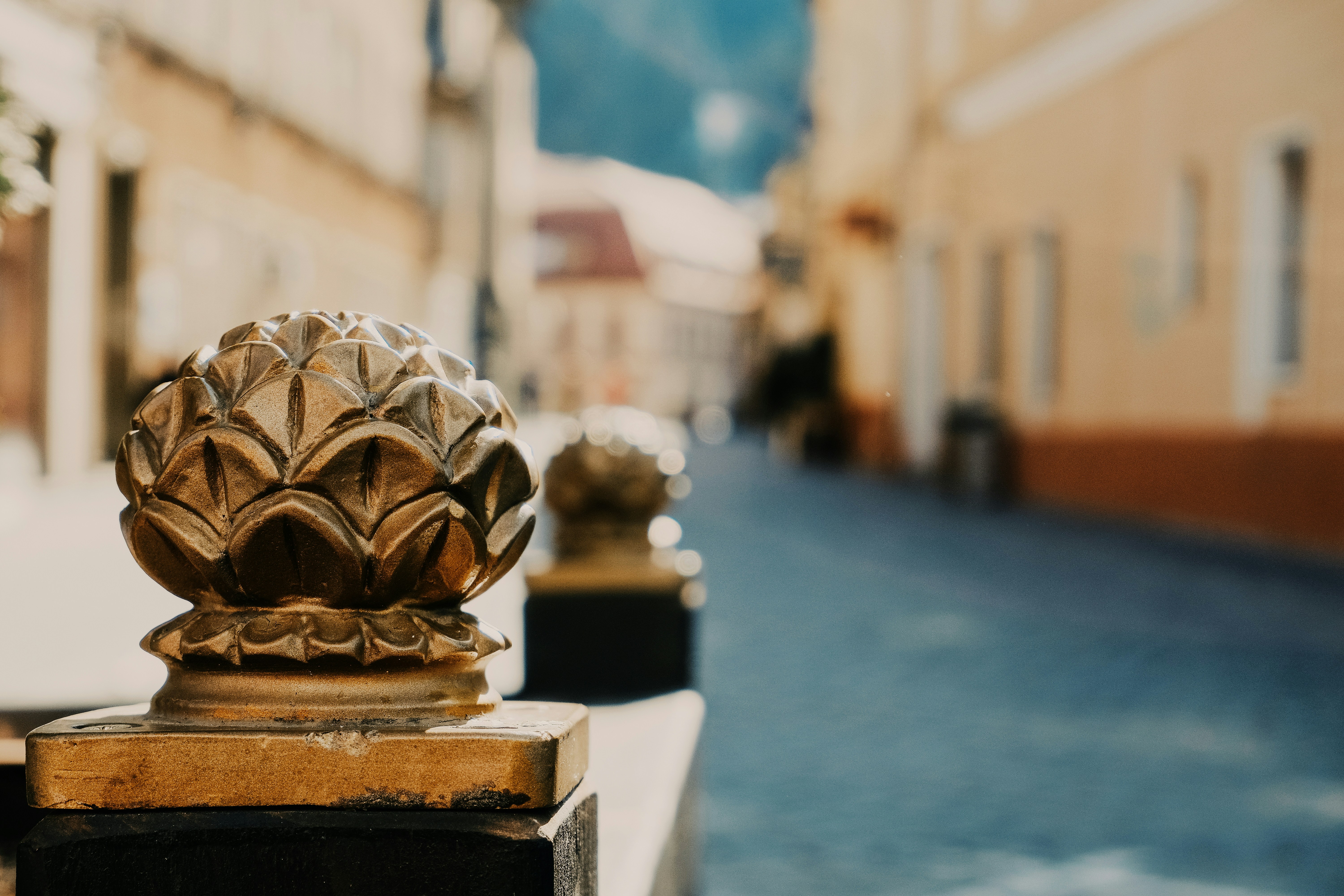 gold ceramic figurine on white concrete surface