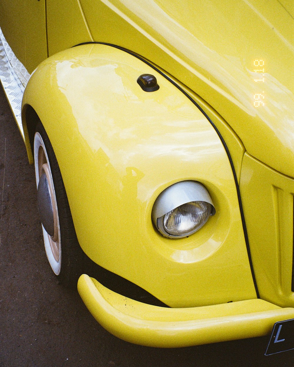 yellow car on gray asphalt road