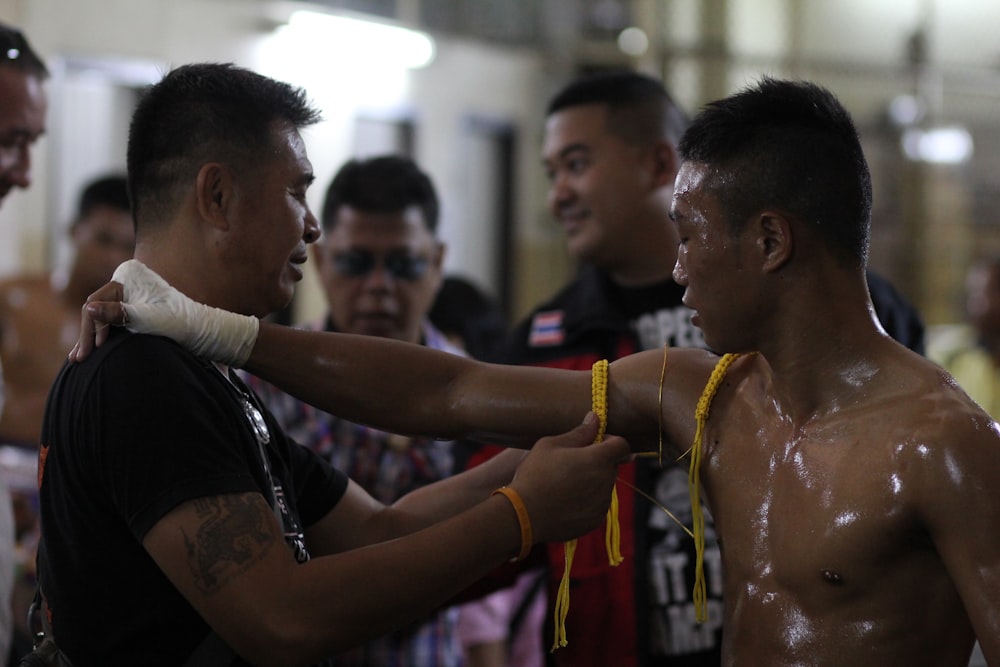 man in black shirt holding yellow rope