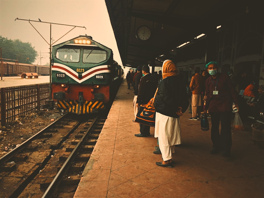 people standing beside train station during daytime