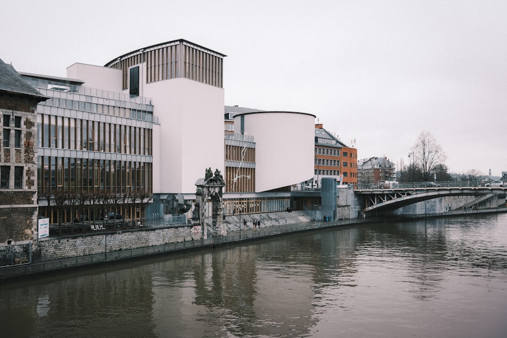 white concrete building near river during daytime