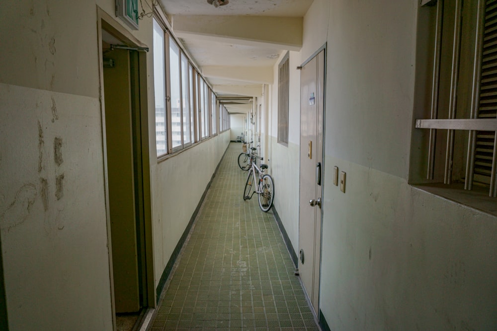 white bicycle on hallway during daytime